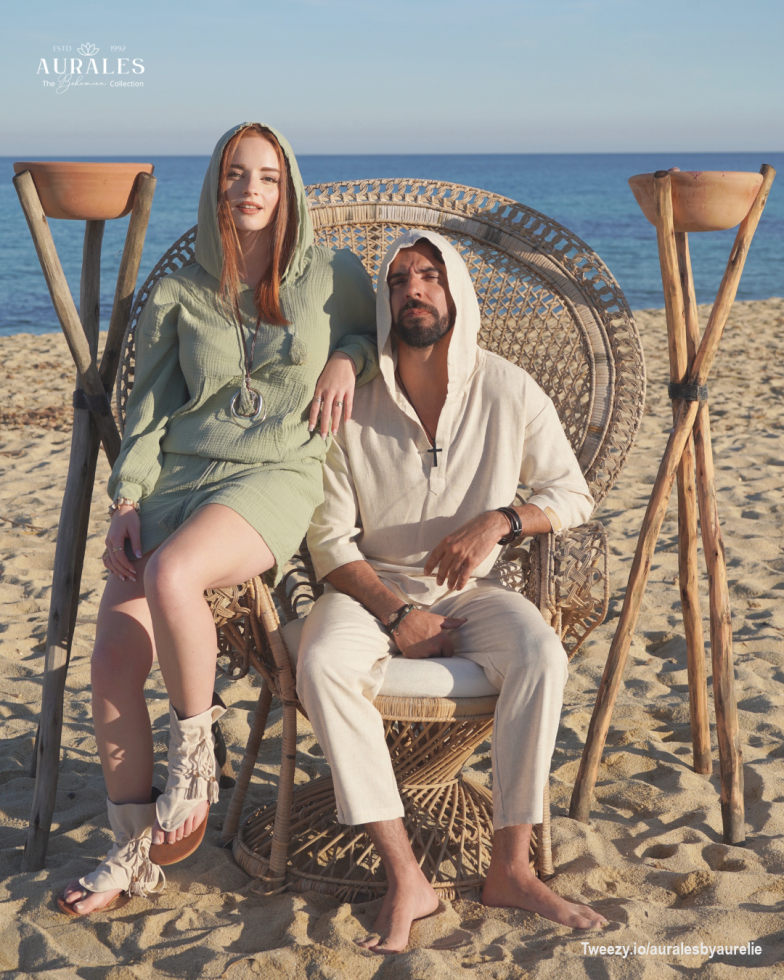 <p>Unwind in style with this chic, <strong>hooded ensemble</strong> from the&nbsp;<em>Aurales Bohemian Collection</em>. Her sage green hooded dress paired with bohemian-inspired sandals creates a look that is both playful and elegant. His minimalist off-white hooded tunic and lightweight trousers exude a sense of calm and relaxation, perfect for sunset lounging. Together, they embody the ultimate laid-back beach vibe, where comfort meets timeless coastal fashion.</p>