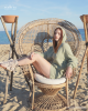 <p>Combining comfort and chic, this look from the <em>Aurales Bohemian Collection</em> is for those who enjoy lounging by the sea with a touch of bohemian elegance. The soft sage-green hooded dress drapes gently, offering both style and ease, while the playful gladiator-style sandals add a rustic, free-spirited vibe. This outfit captures the essence of a laid-back day at the beach with a focus on natural beauty and relaxed sophistication.</p>